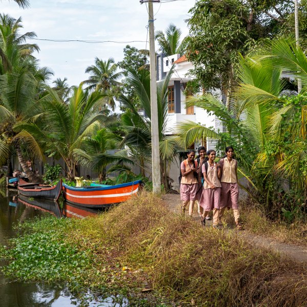 Boats travel along the backwaters near Alleppey, Kerala, India.