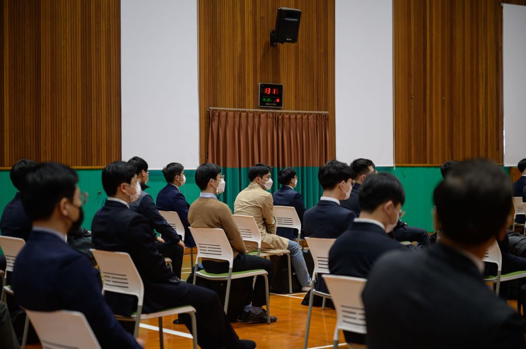 South Korean Jehovah's Witnesses, who are conscientious objectors to mandatory military service, await an induction session at a correctional facility where they will begin working, in Daejeon on October 26, 2020. (ED JONES/AFP via Getty Images)