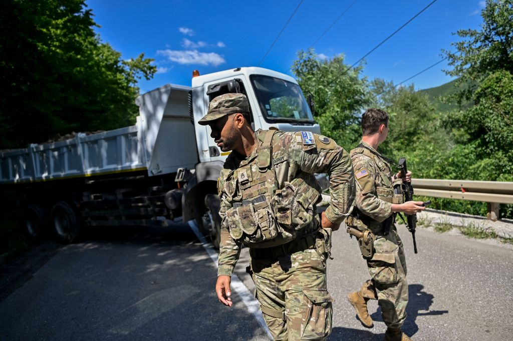 U.S. NATO soldiers serving in Kosovo patrol next to a road barricade set up by ethnic Serbs near the town of Zubin Potok on Aug. 1, 2022. (Armend Nimani—AFP via Getty Images)