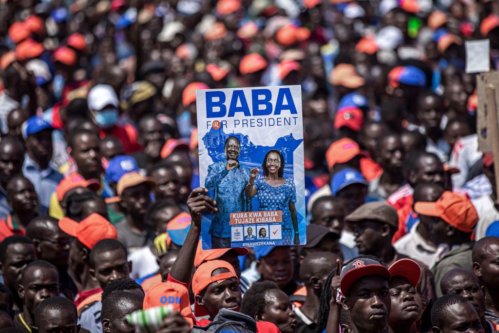 A voter waves a poster portraying presidential candidate Raila Odinga and his running mate Martha Karua during a campaign rally in Jomo Kenyatta International Stadium in Kisumu, Kenya on Aug. 4, 2022, ahead of Kenya's general election. (Patrick Meinhardt—AFP via Getty Images)