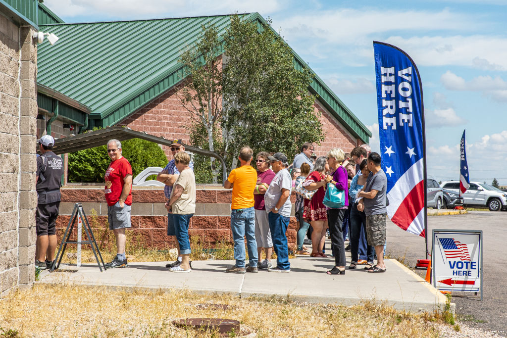 Voters wait in line to cast ballots outside a polling location at North Christian Church in Cheyenne, Wyoming, on Aug. 16, 2022. (David Williams—Bloomberg via Getty Images)