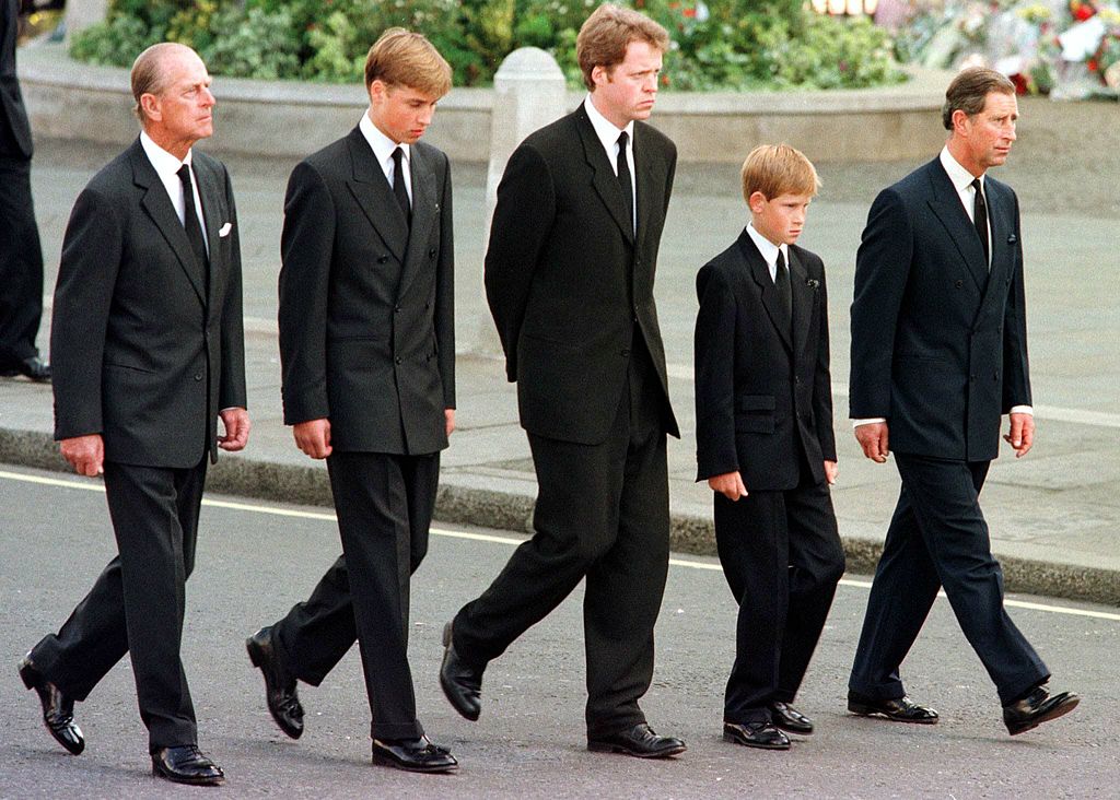 (L to R) The Duke of Edinburgh, Prince William, Earl Spencer, Prince Harry, and Prince Charles walk outside Westminster Abbey during the funeral service for Diana, Princess of Wales, on Sept. 6, 1997. Hundreds of thousands of mourners lined the streets of Central London to watch the funeral procession. (Jeff J. Mitchell—AFP via Getty Images)