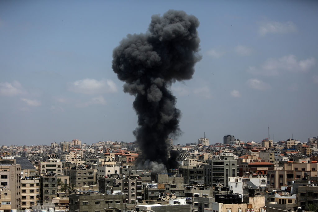 Flames and smoke rise from a residential building following a deadly Israeli airstrike on Aug. 6, 2022 in Gaza City. (Mohammed Dahman—Getty Images)