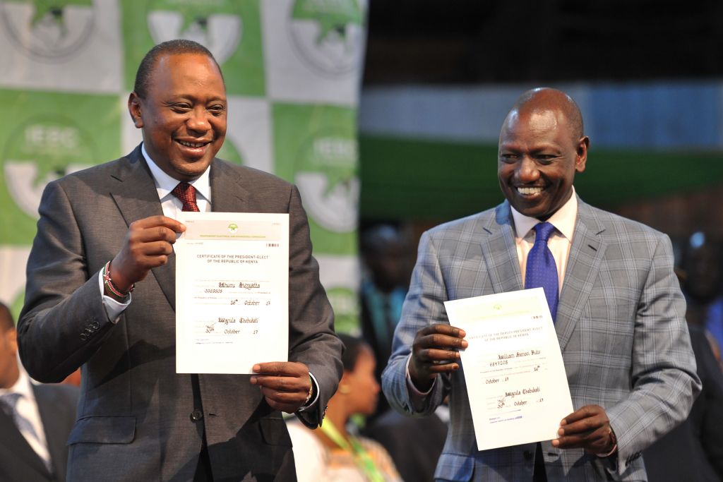 Kenya's president-elect, Uhuru Kenyatta (L) with his running mate William Ruto hold up certificates of election on Oct. 30, 2017 at the national tallying center at Bomas of Kenya, where they were announced winners of a repeat presidential poll by the Independent Electoral and Boundaries Commission chairman. Kenyatta was declared victor of the country's deeply divisive elections on Oct. 30, taking 98 percent of the ballots cast in a poll boycotted by his rival Raila Odinga. (Tony Karumba—AFP via Getty Images)