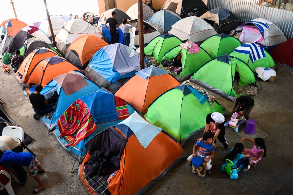 Children play around tents at the Movimiento Juventud 2000 shelter for migrants seeking asylum in the United States as Title 42 and "Remain In Mexico" border restrictions continue, in Tijuana, Baja California state, Mexico on April 9, 2022. (Patrick T. Fallon—AFP via Getty Images)