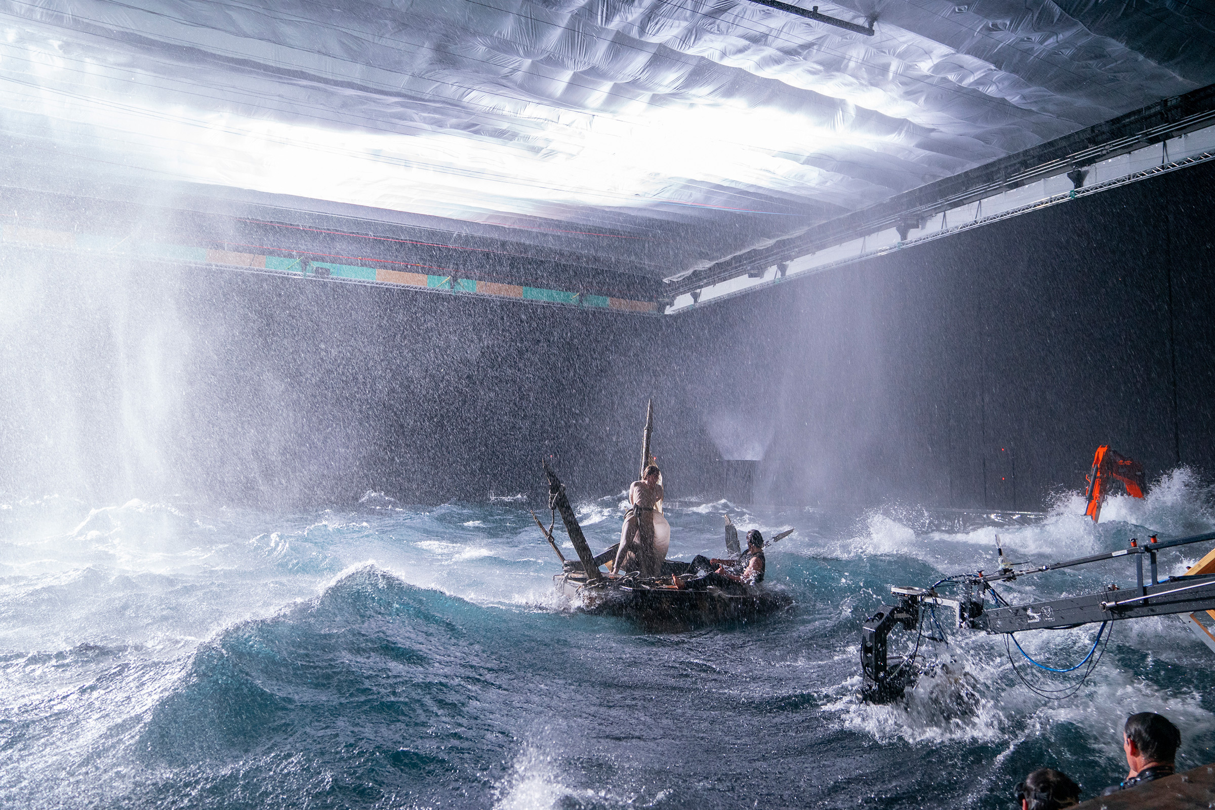 Galadriel (Morfydd Clark) and Halbrand (Charlie Vickers) grapple with a fake storm while filming in a massive water tank (Ben Rothstein—Prime Video)