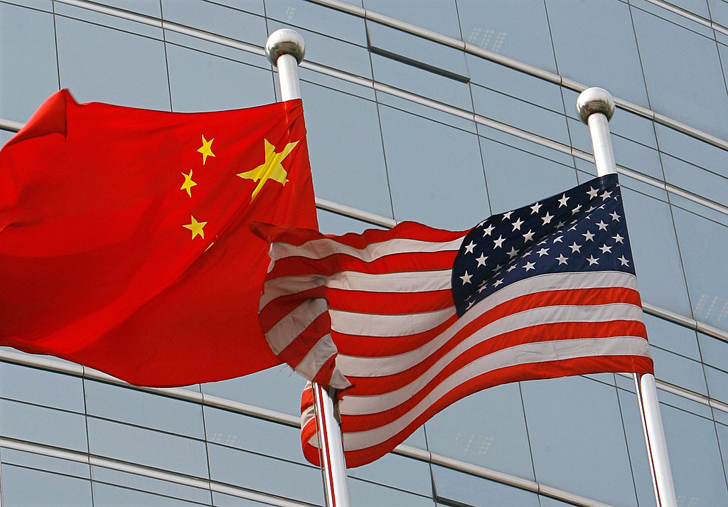 A U.S. and a Chinese flag wave outside a commercial building in Beijing, July 9 2007. (TEH ENG KOON/AFP— Getty Images)