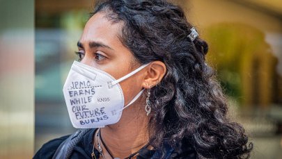 NYC: A climate activist wearing a mask at a rally outside the JPMorgan headquarters at JPMorgan Annual Shareholder Meeting