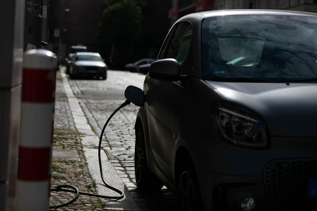 An electric vehicle (EV) at a charging station in central Berlin, Germany, on Tuesday, Aug. 9. 2022. (Krisztian Bocsi—Bloomberg/Getty Images)