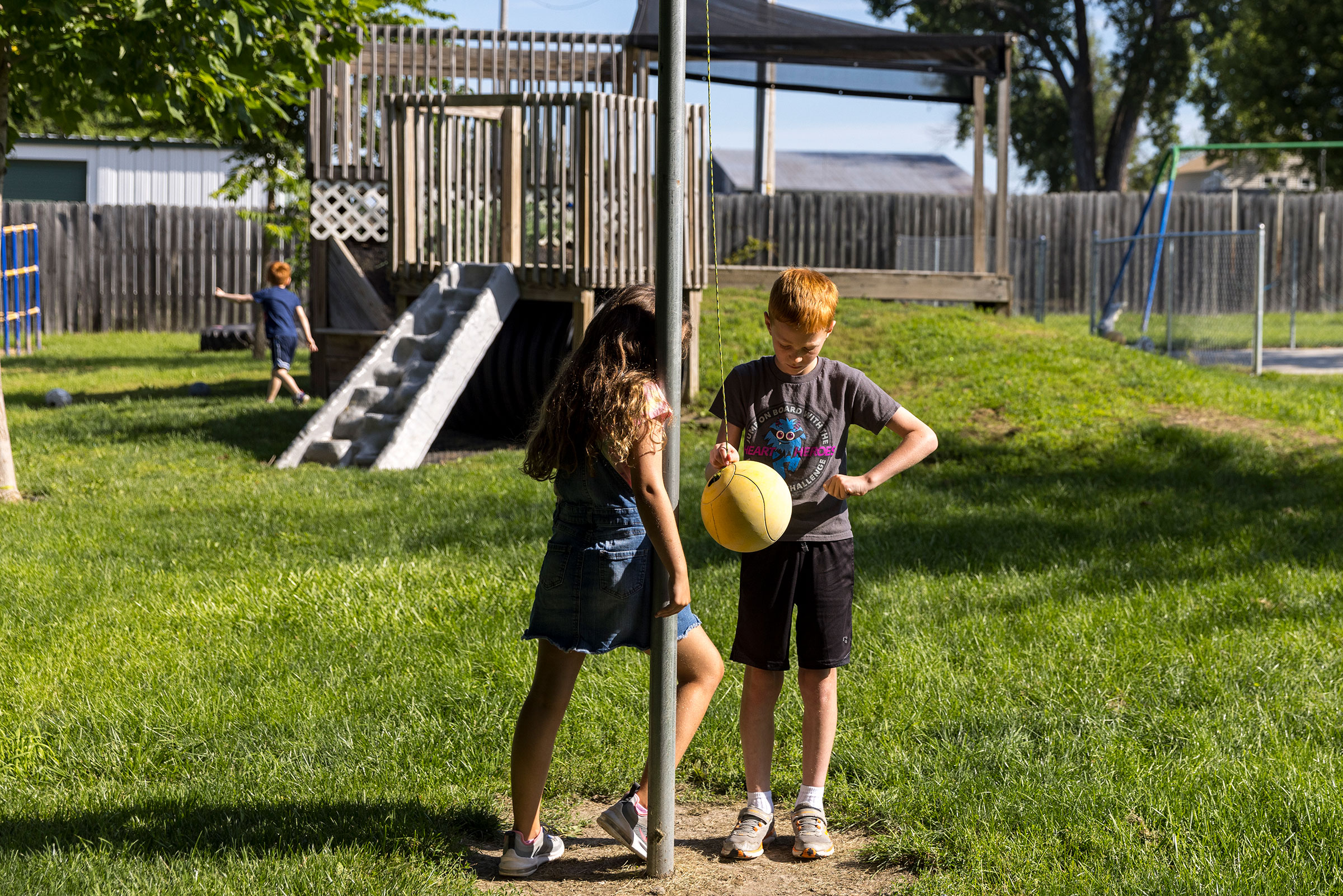 Hunter Rutkowski, age 10, and Alice Nefzger, age 8, play outside. While they will return to school soon, some parents with young children are still trying to cobble together a new childcare arrangement.