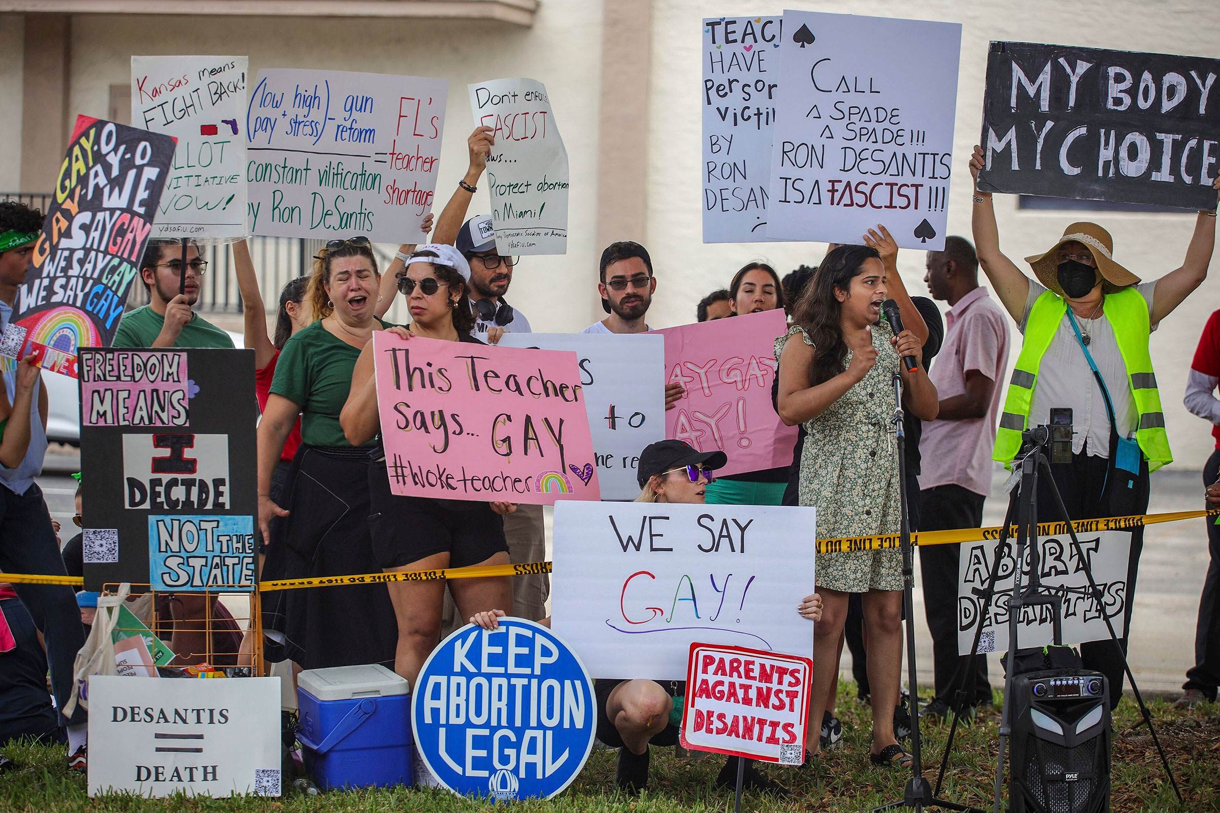 Protestors gather outside the Metro-Dade Firefighters Local 1403 at an event for conservative school board candidates in Doral, Fla. on Aug. 21 2022. The enforcement of Florida's HB 1557—which critics have dubbed the "Don't Say Gay" law—has varied widely by school district. (Carl Juste—Miami Herald/AP)