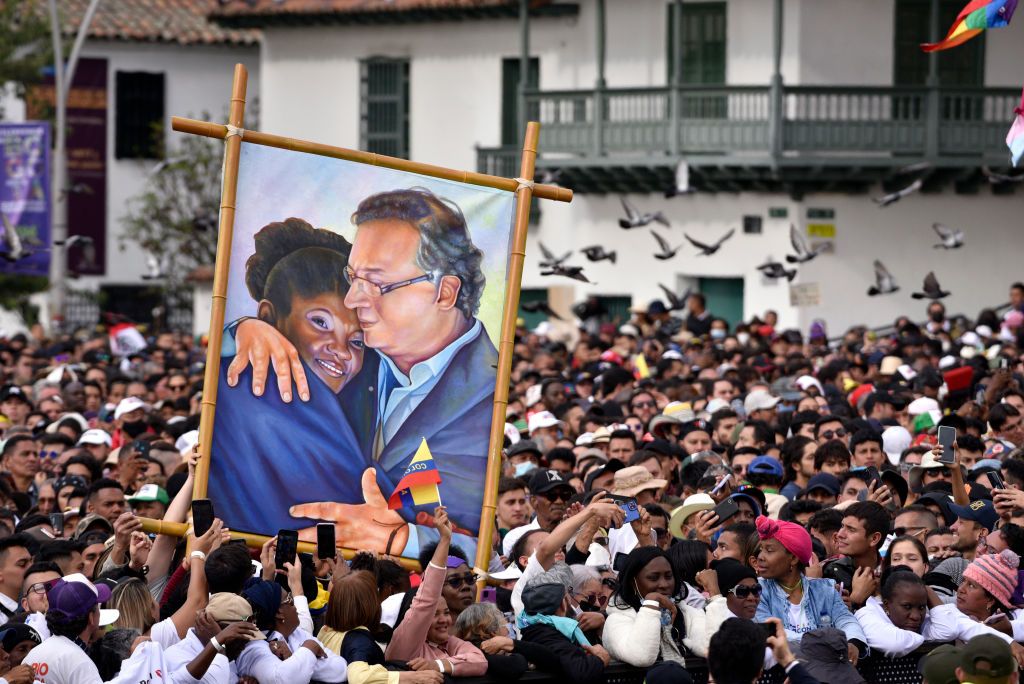 Supporters of President Gustavo Petro of Colombia hold a painting depicting him and his Vice President, Francia Márquez, during the presidential inauguration at Plaza Bolivar on Aug. 7, 2022 in Bogotá, Colombia. (Guillermo Legaria—Getty Images)