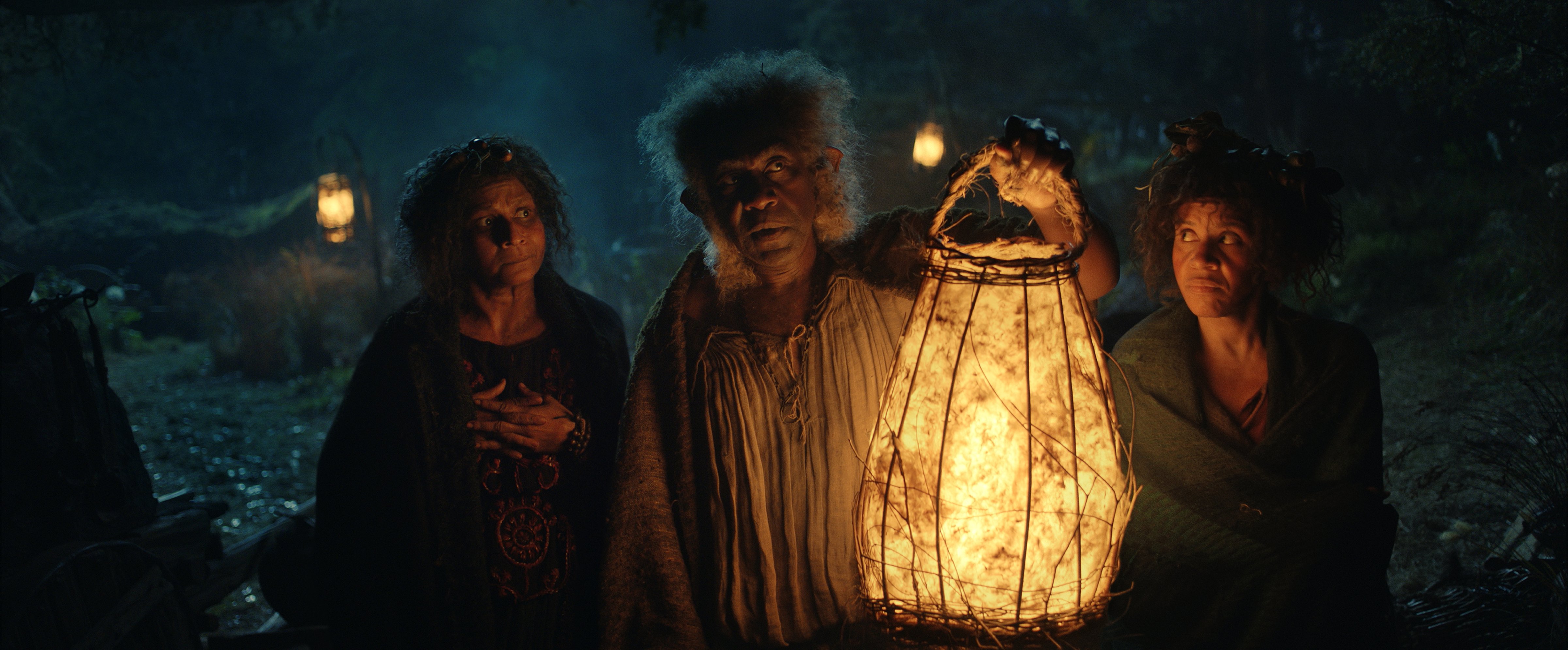 Thusitha Jayasundera, Lenny Henry, and Sara Zwangobani in <i>The Rings of Power</i> (Prime Video)