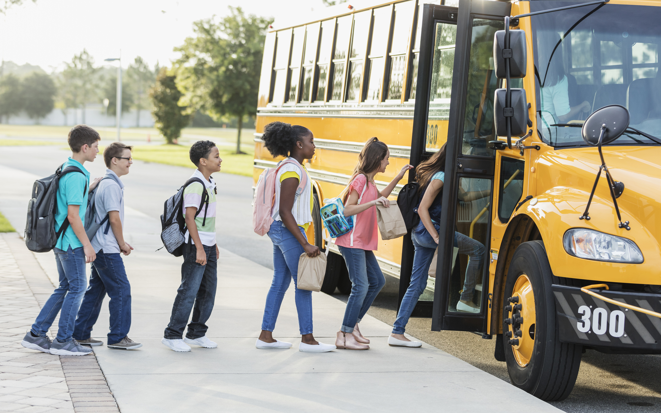 Middle school students boarding a bus