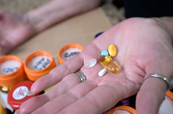 A hand showing daily prescription medications