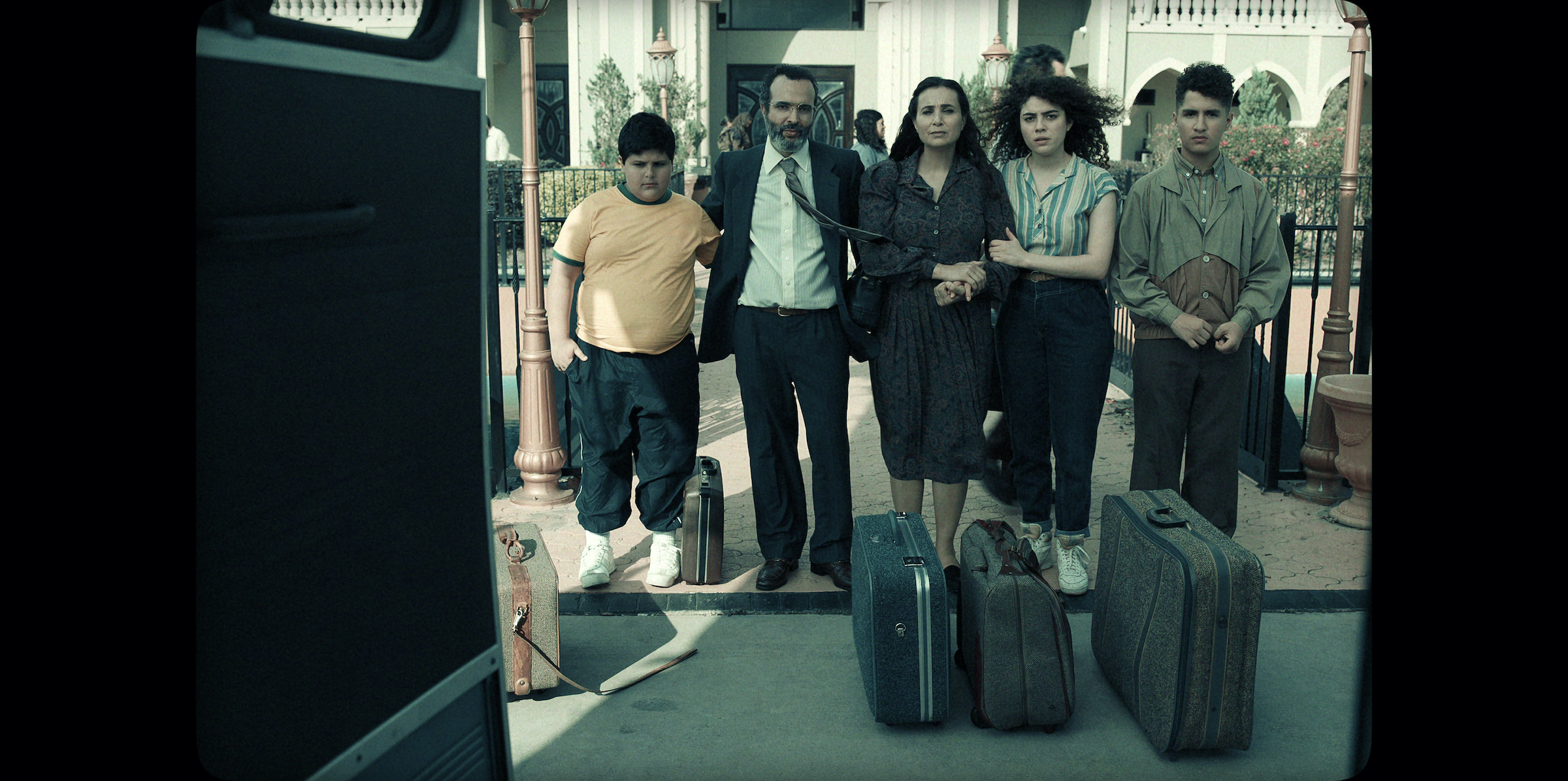 In a flashback, Mo's family lines up in front of a bus to leave Kuwait. (Courtesy of Netflix)