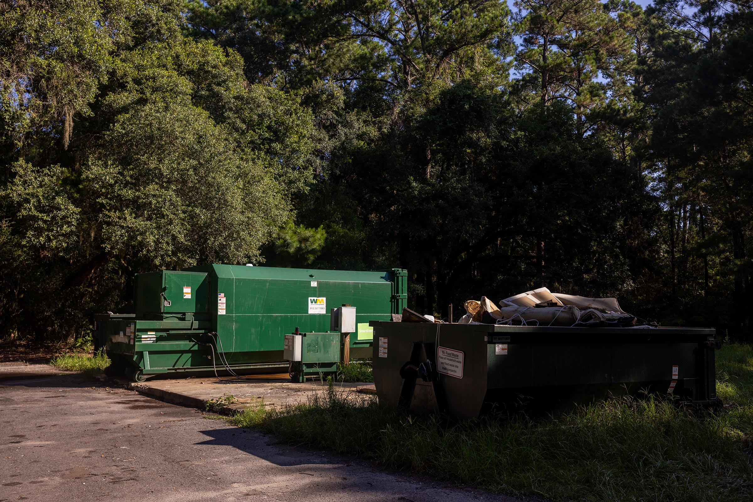 The island's trash dump site where residents and visitors must cart their own trash and place certain items such as food waste into a green trash compactor.