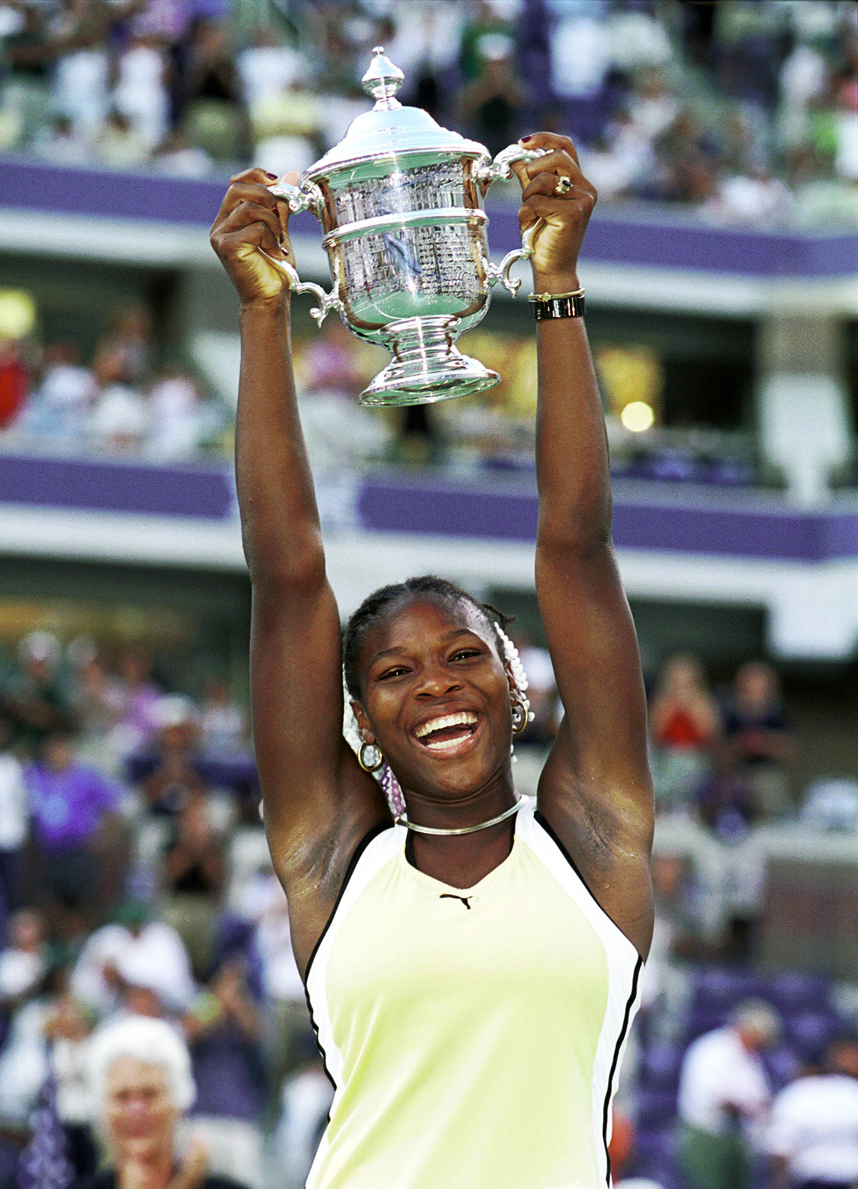 Serena raises the 1999 U.S. Open championship trophy, her first major win. She was 17 (Ron C. Angle—Getty Images)