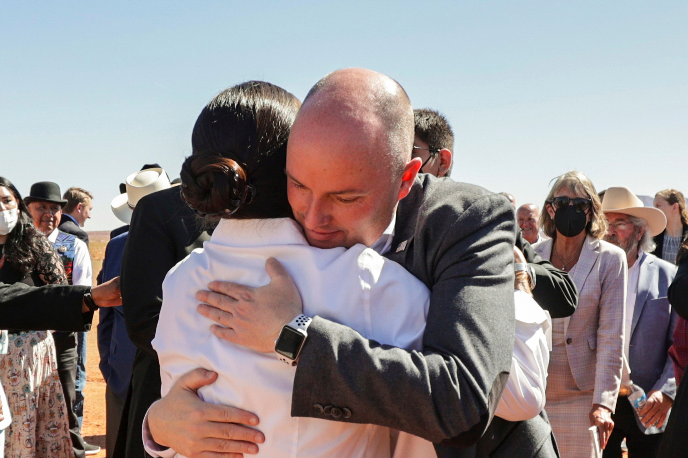 U.S. Interior Secretary Deb Haaland, left, and Gov. Spencer Cox, right, hug after signing the Navajo Utah Water Rights Settlement Act