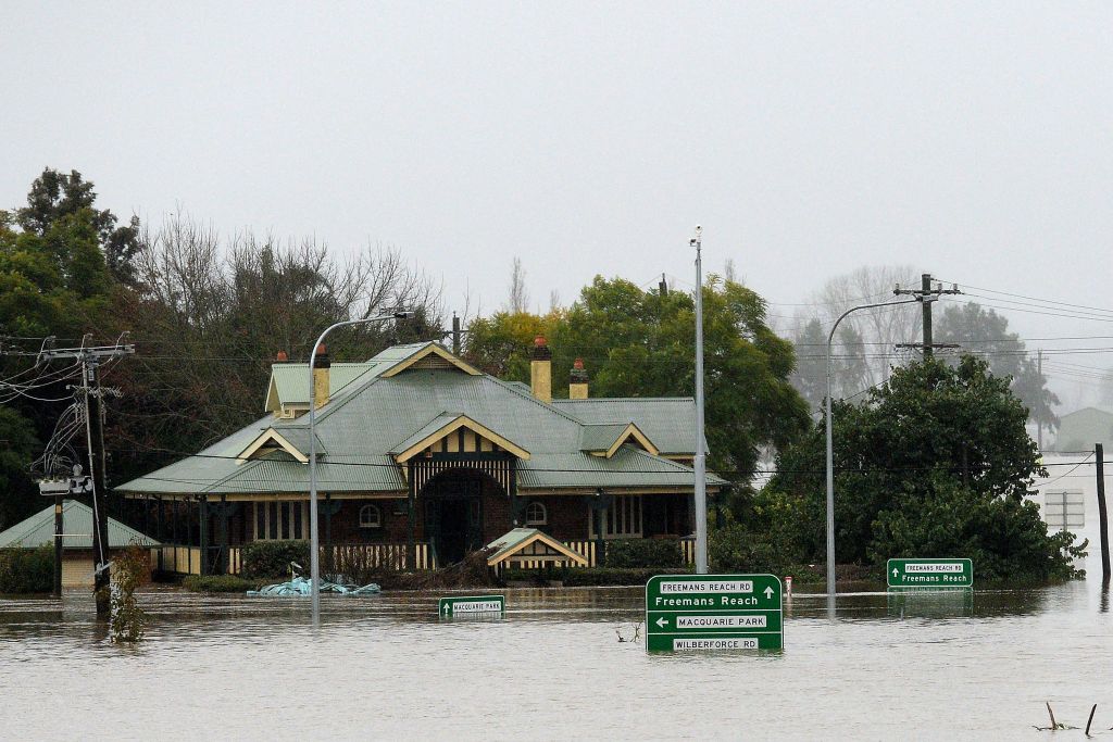 A general view of a flooded residential area next to the overflowing Hawkesbury River in the northwestern Sydney suburb of Windsor on July 6, 2022. Thousands of Australians were ordered to evacuate their homes in Sydney as torrential rain battered the country's largest city and floodwaters inundated its outskirts. (Muhammad Farooq—AFP/Getty Images)