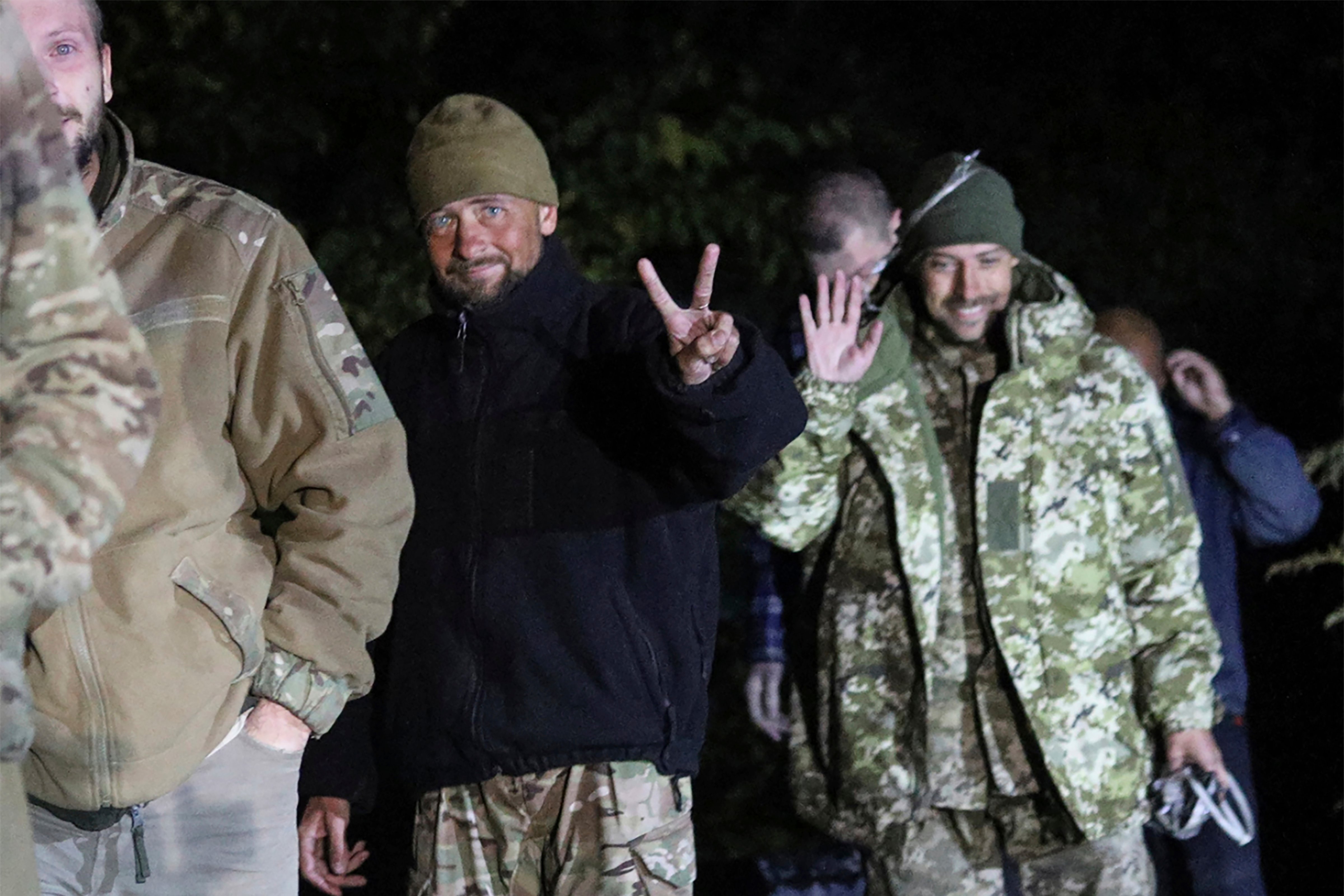Ukrainian soldiers, who were released in a prisoner exchange between Russia and Ukraine, smile close to Chernihiv, Ukraine, late Wednesday, Sept. 21, 2022. Ukraine announced a high-profile prisoner swap early Thursday that culminated months of efforts to free many of the Ukrainian fighters who defended a steel plant in Mariupol during a long Russian siege. (Ukrainian Security Service Press Office/AP)