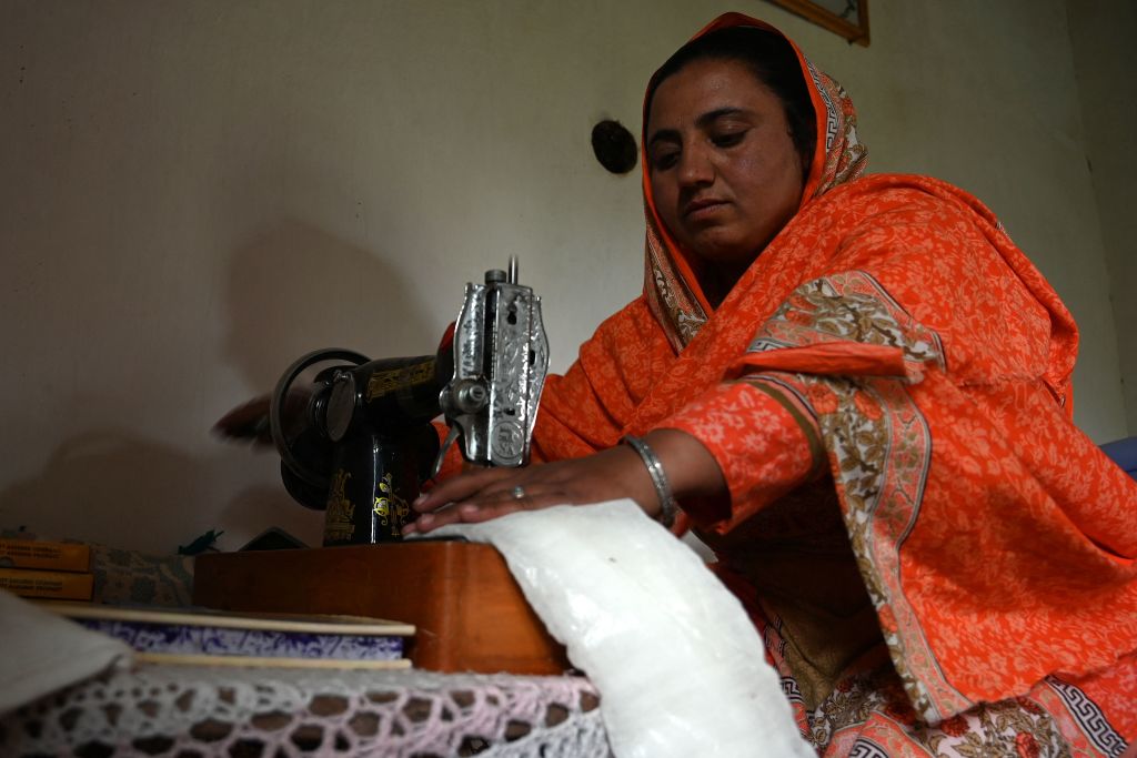 In this photo taken on May 18, 2019, Pakistani woman Hajra Bibi makes a sanitary napkin with a sewing machine at her home in Buni village in Chitral.  (AAMIR QURESHI/AFP via Getty Images)