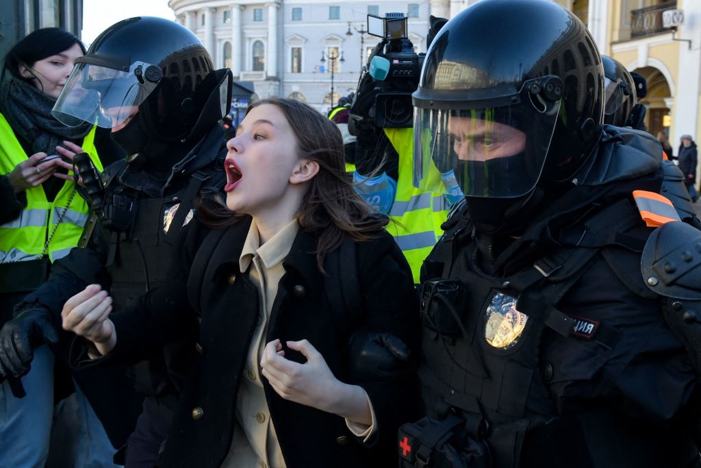 Polis memurları, 13 Mart 2022'de Saint Petersburg'un merkezinde, Ukrayna'daki Rus askeri harekâtına karşı düzenlenen bir protesto sırasında bir kadını gözaltına aldı. (AFP aracılığıyla Getty Images)