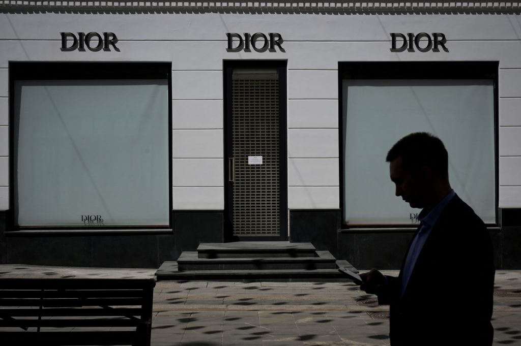 A man walks past a closed Dior boutique in Moscow on June 8, 2022. (NATALIA KOLESNIKOVA/AFP via Getty Images)