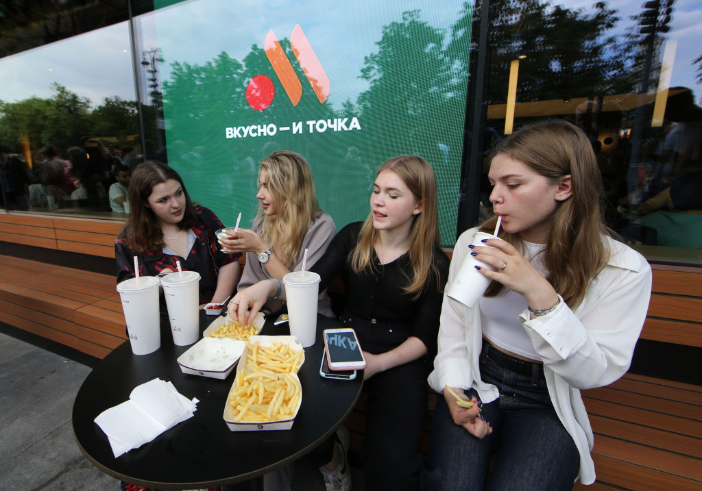 People visit a newly opened fast food restaurant in a former McDonald's outlet in Pushkinskaya Square, on June 12, 2022 in Moscow, Russia. The first of the former McDonald's restaurants has reopened under a new brand called "Vkusno i tochka" ("Tasty and point") in Moscow, after the corporation sold its branches in Russia to a local businessman following sanctions after Russia invaded Ukraine. (Contributor/Getty Images)