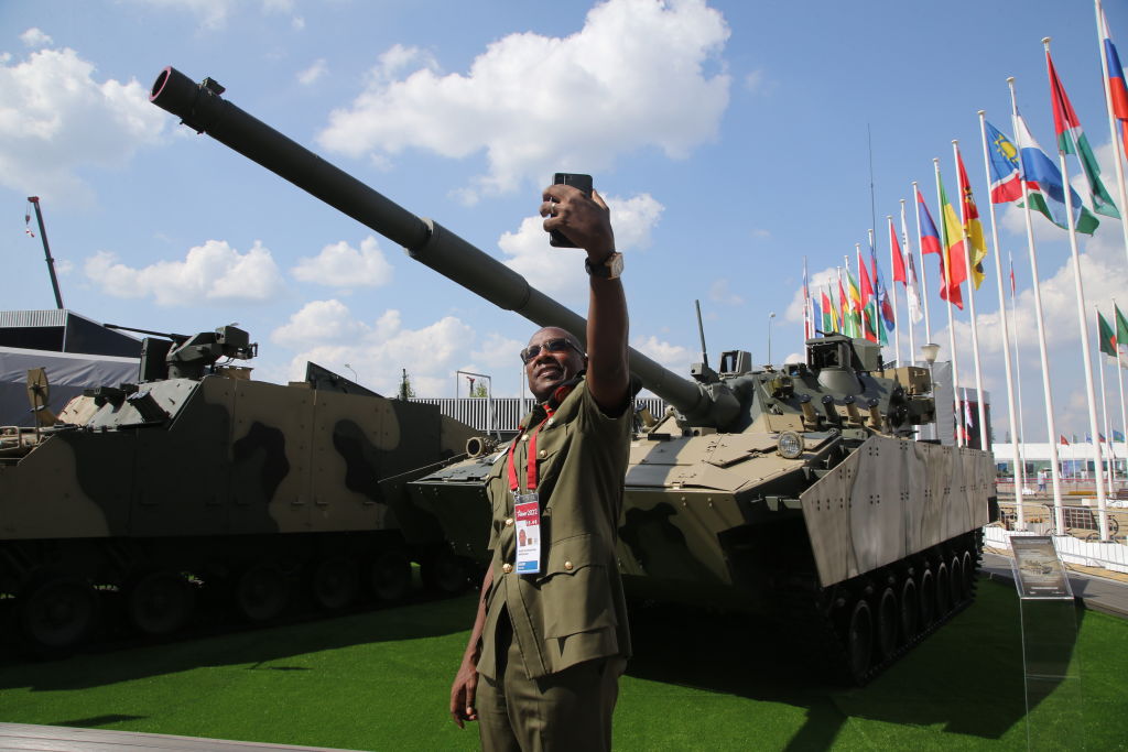 An officer from Uganda poses for a selfie photo in front the 2S25 Sprut-SD ("Kraken SD") self-propelled anti-tank gun during the International Military Technical Forum 'Army 2022', on August 15, 2022, in Kubinka, outside of Moscow, Russia. (Contributor/Getty Images)