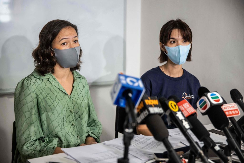 Human rights lawyer Patricia Ho (L) and Programme Manager at STOP, an anti-trafficking NGO, Michelle Wong (R), speak to the media in Hong Kong on August 24, 2022, about Hong Kong residents being trafficked into South East Asia and forced to work in scam syndicates. (ISAAC LAWRENCE/AFP via Getty Images)