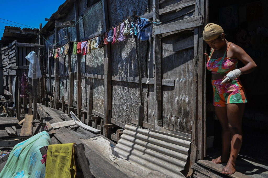 A woman stands at the doorway of her house at the Coelho favela on the banks of Capibaribe river in Recife, Pernambuco, northeast Brazil, on Sept. 10, 2022. Some 33.1 million Brazilians live in hunger, an issue looming large in October presidential elections. (NELSON ALMEIDA/AFP via Getty Images)