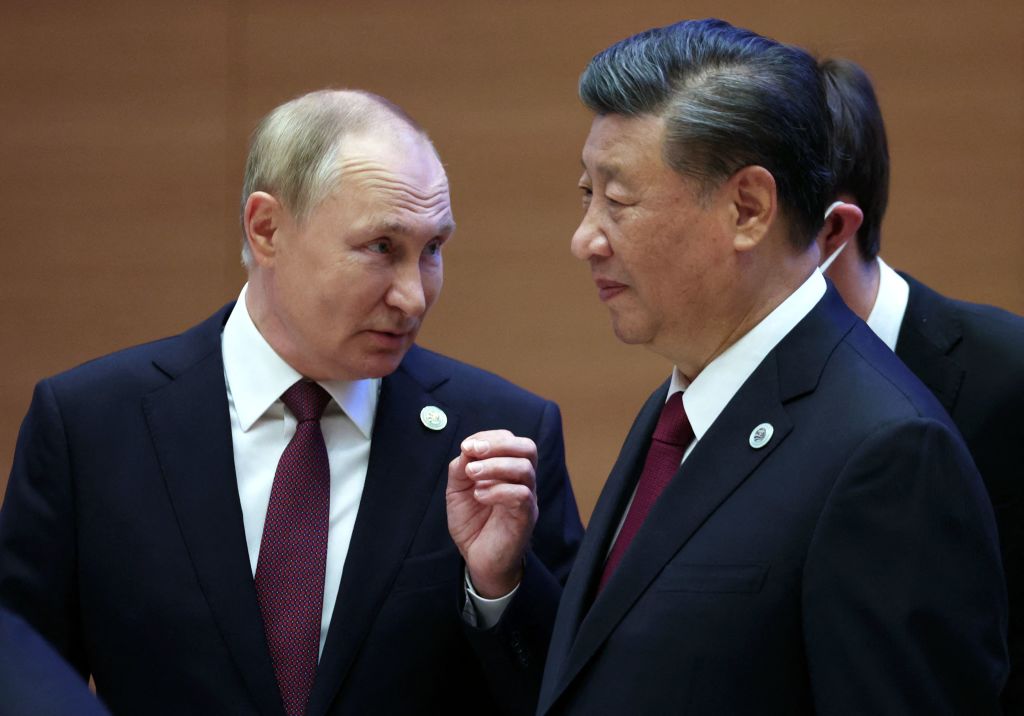 Russian President Vladimir Putin speaks to China's President Xi Jinping during the Shanghai Cooperation Organisation (SCO) leaders' summit in Samarkand on Sept. 16, 2022. (SERGEI BOBYLYOV/SPUTNIK/AFP via Getty Images)