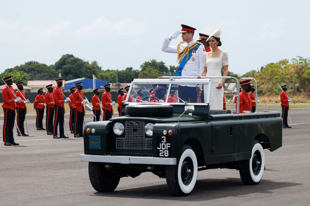 Catherine, Duchess of Cambridge and Prince William, Duke of Cambridge, ride in a Land Rover as they attend the inaugural Commissioning Parade for service personnel from across the Caribbean at the Jamaica Defence Force on day six of the Platinum Jubilee Royal Tour of the Caribbean on Mar. 24, 2022 in Kingston, Jamaica. (Samir Hussein—WireImage via Getty Images)