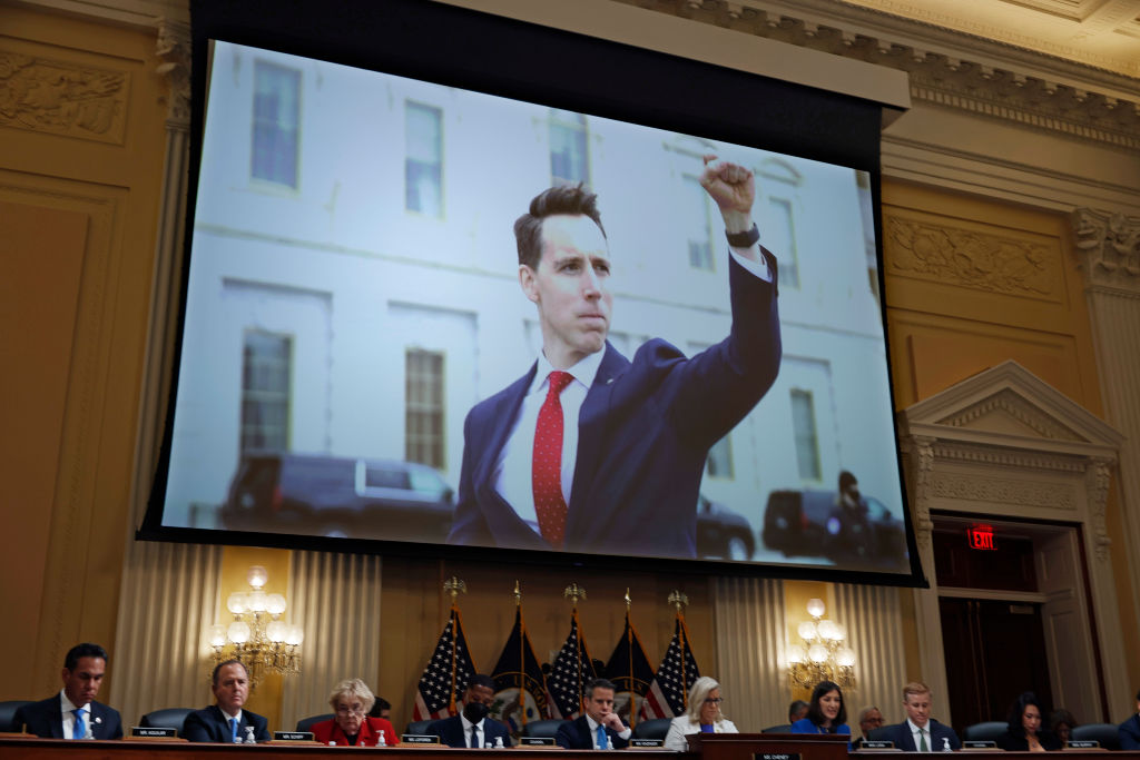 A photograph of Sen. Josh Hawley, Republican of Missouri, pumping his fist toward the rioters on January 6, 2021, is shown during a hearing of the House Select Committee to Investigate the attack on the U.S. Capitol on July 21, 2022 in Washington, DC. (Tasos Katopodis—Getty Images)