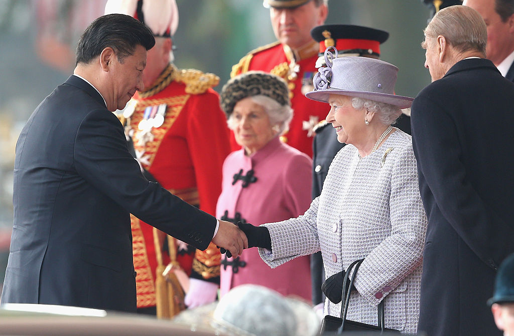 Queen Elizabeth II shakes hands with Chinese President Xi Jinping on Horseguards Parade during the Official Ceremonial Welcome for the Chinese State Visit on Oct. 20, 2015 in London, England. (Chris Jackson—WPA Pool /Getty Images)