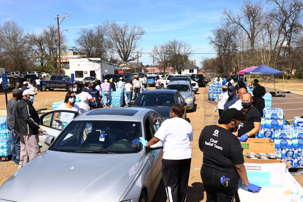 Volunteers help to distribute water at a water and food distribution drive held by College Hill Baptist Church and the World Central kitchen in Jackson, Mississippi, on  on March 07, 2021. (Michael M. Santiago—Getty Images)