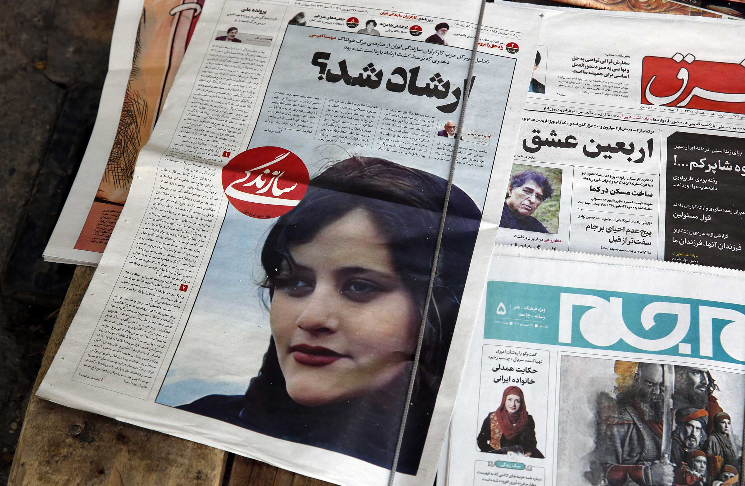 Iranian newspapers report on the death of Mahsa Amini, a woman who died in custody after being detained by a police unit in charge of enforcing  mandatory hijab rules in Tehran, Sept. 18, 2022. (Bedin Taherkenareh—EPA-EPE/Shutterstock)