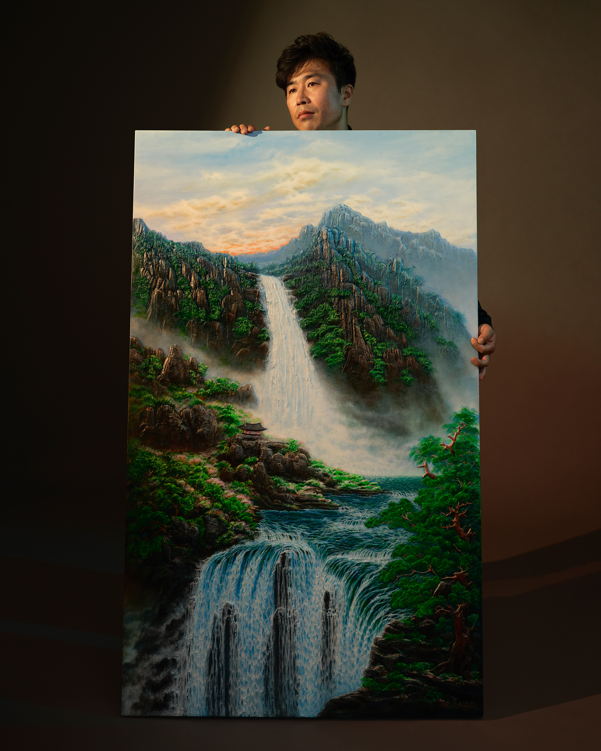 Artist Surl Lee, photographed alongside his artwork on Sept. 9. Lee says what he misses most about North Korea are the beautiful waterfalls. (Catherine Hyland for TIME)