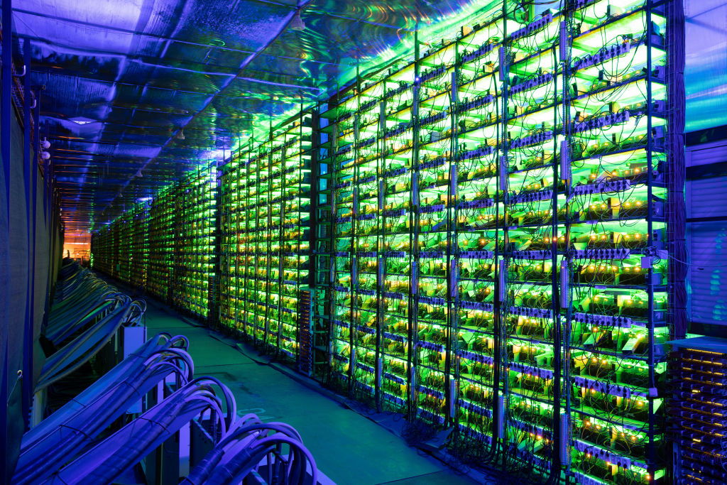 Racks of illuminated mining rigs at the Minto cryptocurrency mining center in Nadvoitsy, Russia, on Friday, Dec. 17, 2021. (Andrey Rudakov—Bloomberg/Getty Images)