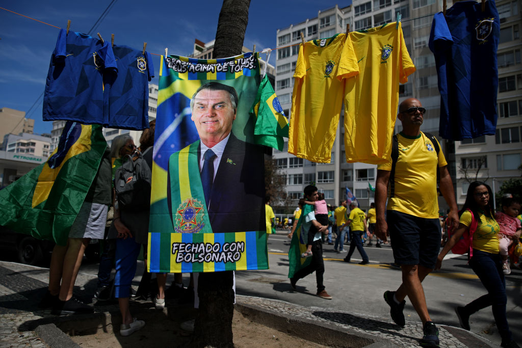 A flag is sold of Brazilian President Jair Bolsonaro on Brazil's Independence Day Celebration in Copacabana on Wednesday, Sept. 7, 2022 in Rio de Janeiro, Brazil. Bolsonaro used Brazil's Independence Day Celebration to rally voters ahead of the Oct. 2nd presidential elections. (Gary Coronado/Los Angeles Times—Getty Images))