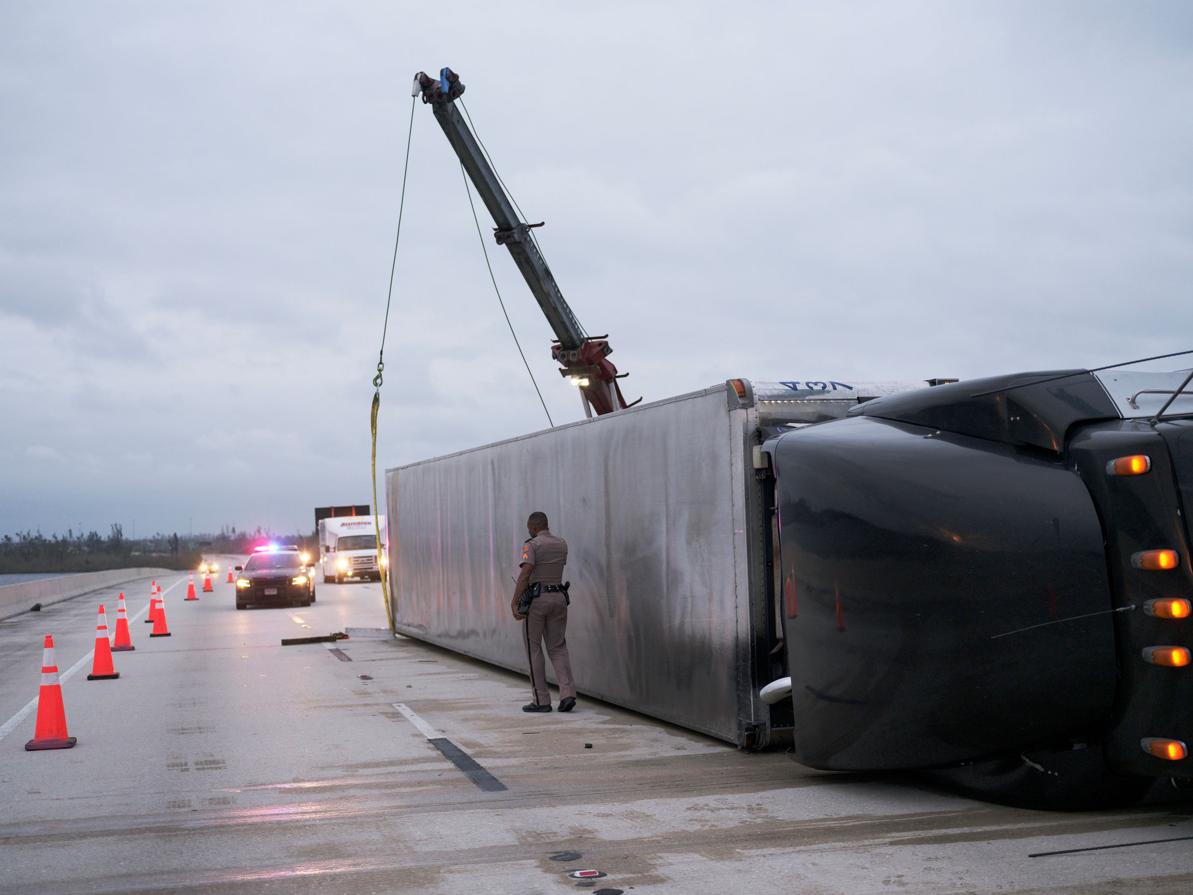 A semi-trailer turned over by Hurricane Ian's strong winds blocks a stretch of the the Albert W. Gilchrist Bridge between Port Charlotte and Punta Gorda, Fla. (Christopher Morris for TIME)