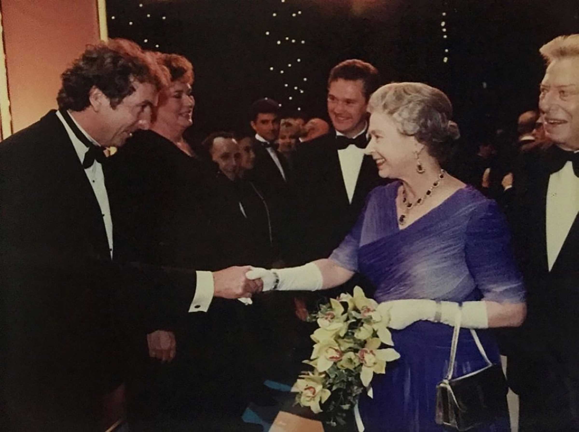 Idle shakes hands with Queen Elizabeth II. (Courtesy Photo)