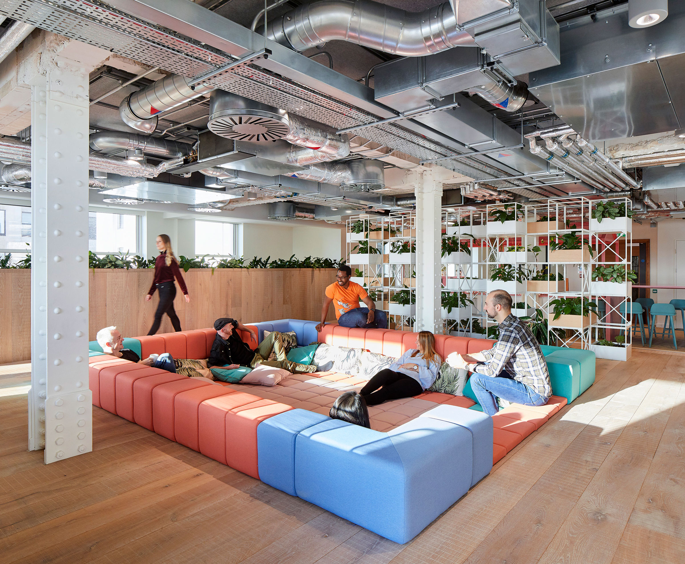 People sitting on a large couch at Spotify’s London headquarters