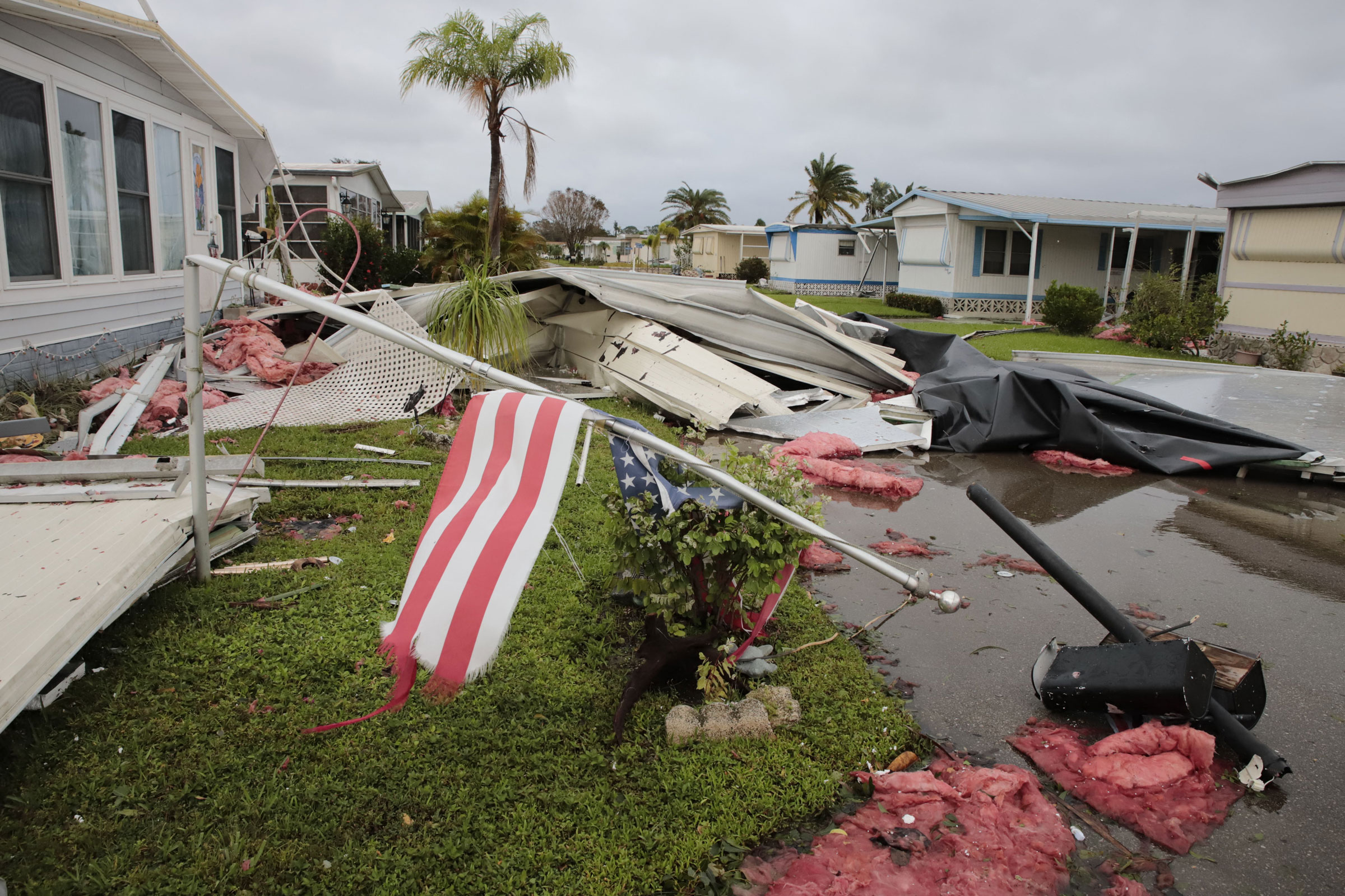 Debris litters a mobile home park in Fort Myers, Fla., on Sept. 29, one day after Hurricane Ian made landfall. (Joseph Agcaoili—AFP/Getty Images)