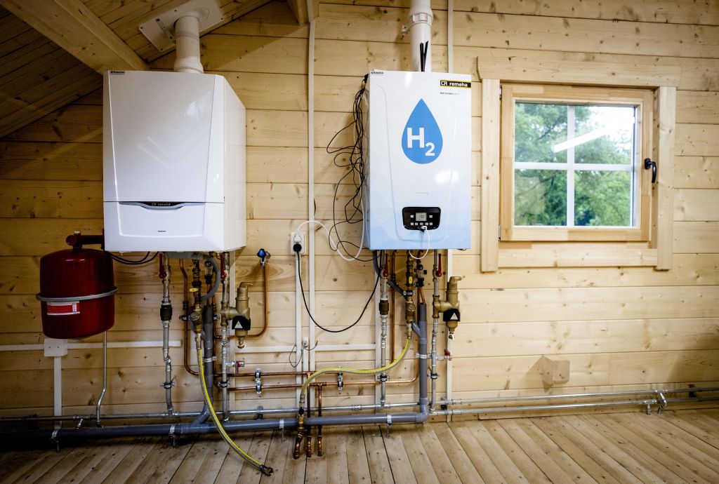An old central heating boiler (L) and a hydrogen boiler inside the Hydrogen Experience Centre in Apeldoorn on May 27, 2021. The house serves as a training location for technicians, who can learn how residences can be powered by hydrogen. (Sem van der Wal/ANP/AFP—Getty Images)