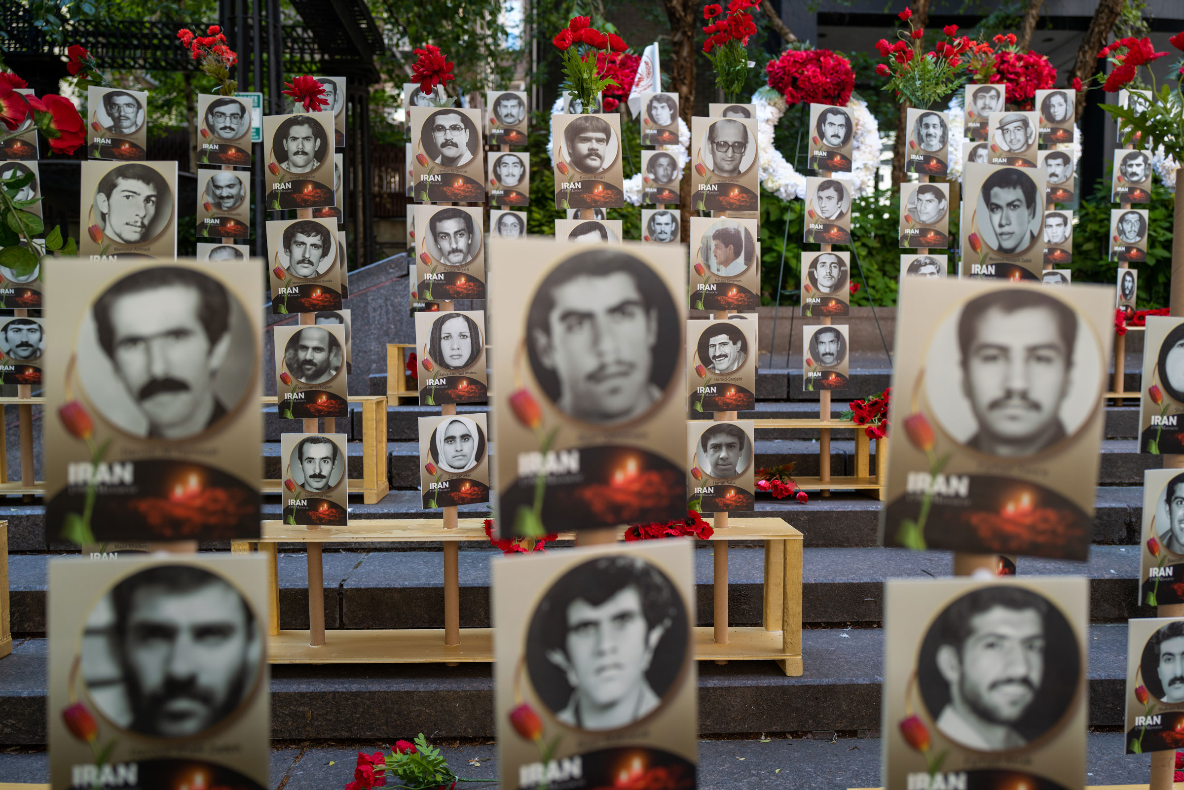 <b>New York, NY</b> Photos showing the victims of the 1988 massacre of Iranian political prisoners are displayed during a protest against Iranian President Ebrahim Raisi outside of the United Nations on Sept. 21, 2022 in New York City. (Spencer Platt—Getty Images)