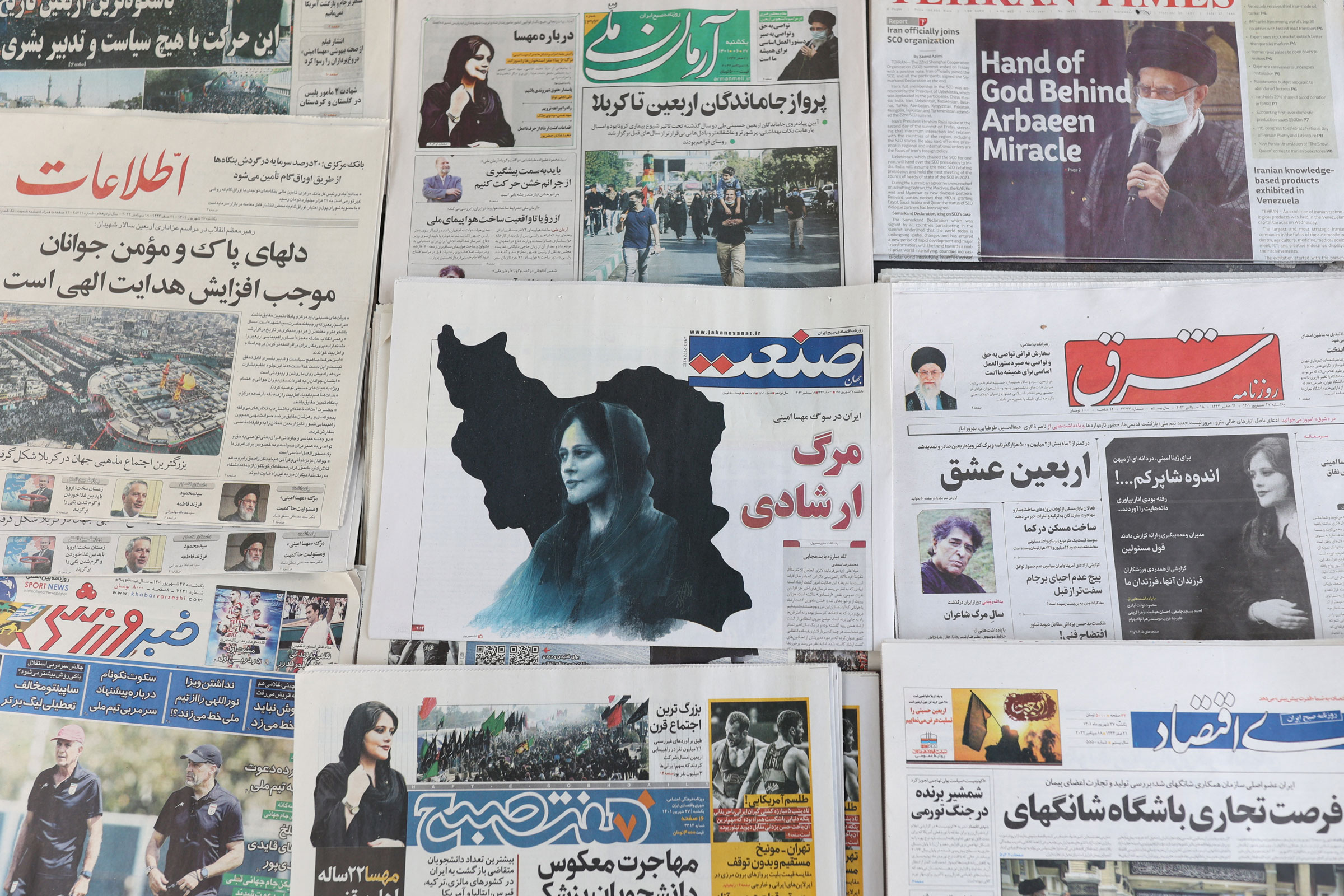 <b>Tehran, Iran</b> Newspapers from Sept. 18, 2022 with a cover picture of Mahsa Amini. (Majid Asgaripour—West Asia News Agency/Reuters)