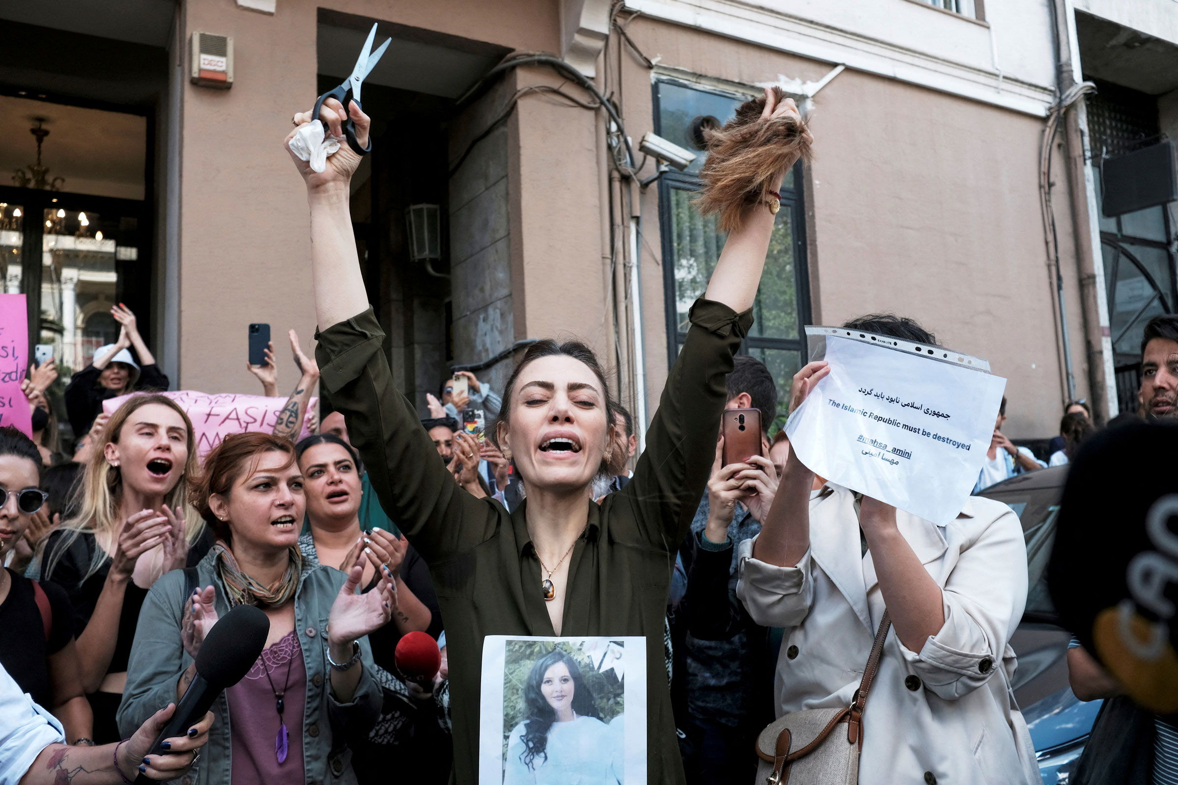 <b>Istanbul, Turkey</b> Nasibe Samsaei, an Iranian woman living in Turkey, reacts after she cut her hair during a protest outside the Iranian consulate in Istanbul, Turkey on Sept. 21, 2022. (Murad Sezer—Reuters)