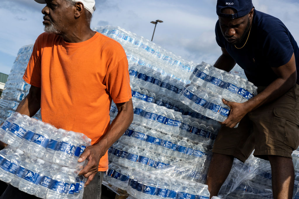 Cases of bottled water are handed out at a Mississippi Rapid Response Coalition distribution site on Aug. 31, 2022 in Jackson, Mississippi. (Brad Vest—Getty Images)